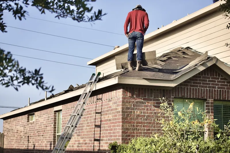 Professional roofer working on a residential roof in Town and Country Estates